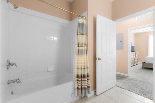 a bathroom with a shower and a bath tub at Orlando Resort Rentals at Universal Boulevard in Orlando