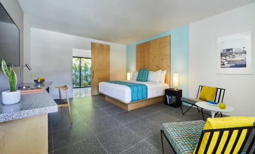 a hotel room with a bed and a kitchen at Twin Palms Resort - Palm Springs Newest Gay Men's Resort in Palm Springs