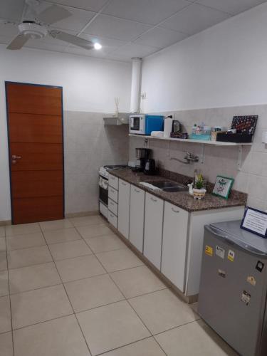 a kitchen with a sink and a counter top at Studio Estrada Escobar in Belén de Escobar
