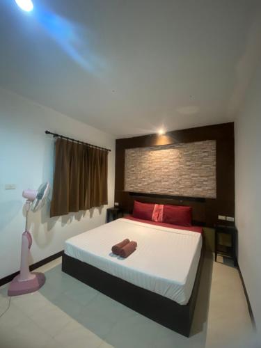 a bedroom with a large bed with red pillows at Pak Klong Room for rent in Phi Phi Don