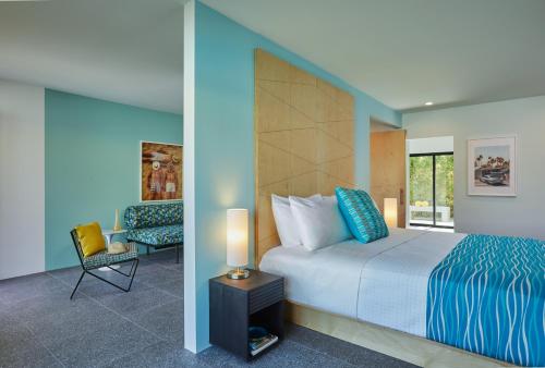 a hotel room with a bed and a chair at Twin Palms Resort - Palm Springs Newest Gay Men's Resort in Palm Springs