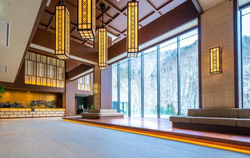 a large lobby with large windows and a large hall at Grand Blissen Hotel Jozankei in Jozankei