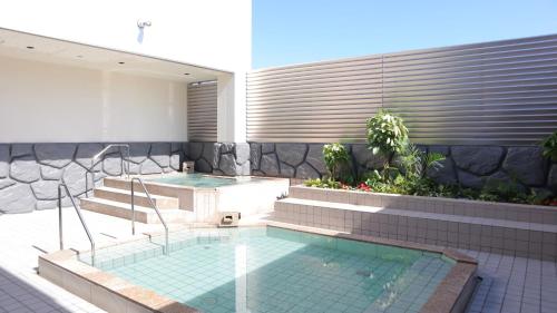 a swimming pool with a hot tub in a house at The Legato Inn MIFUNE in Mifune