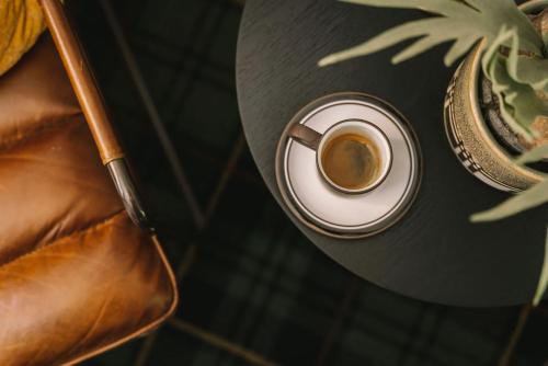 a cup of coffee on a table with a cigarette at St Etienne Daylesford in Daylesford