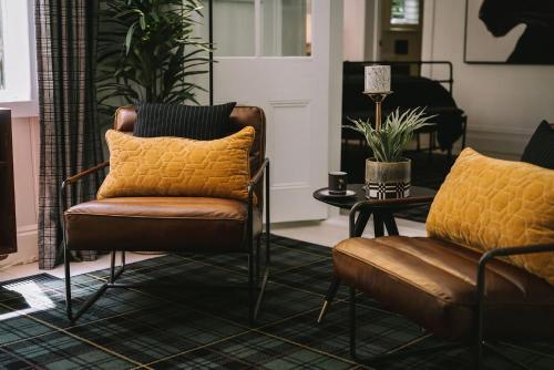 a living room with two chairs and a table at St Etienne Daylesford in Daylesford