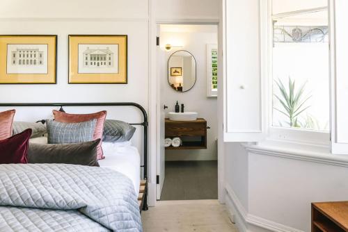 a bedroom with a bed and a sink at St Etienne Daylesford in Daylesford