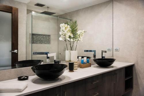 a bathroom with two black bowls on a counter at Amelia Daylesford in Daylesford