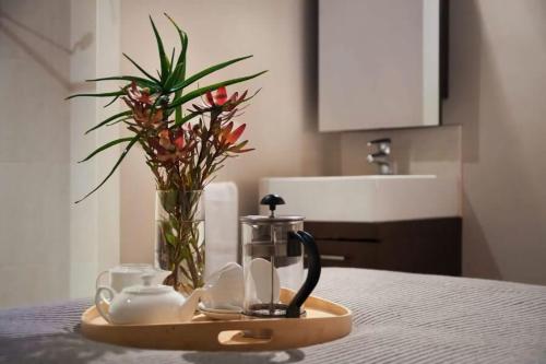 a tray with cups and a tea set on a table at Circa Ivy Prince Daylesford in Daylesford