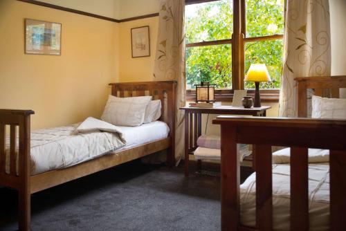 a bedroom with two beds and a window at The Raglan Daylesford in Daylesford