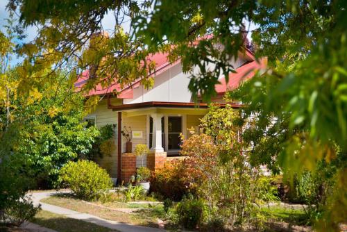 a yellow house with a pink roof at The Raglan Daylesford in Daylesford