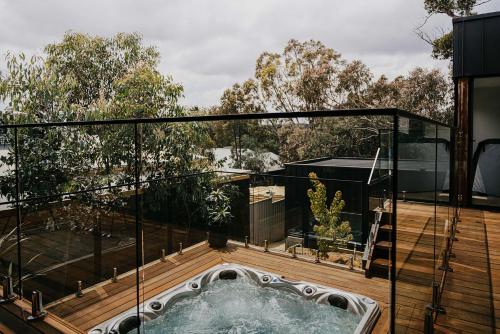 a hot tub on the deck of a house at The Deck - Hepburn Springs Daylesford in Hepburn