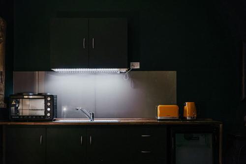 a kitchen with a sink and a microwave at Istana Lodge - Daylesford Region in Musk Vale