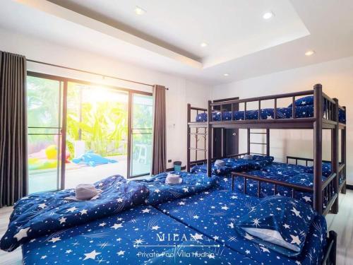 two bunk beds in a room with a mural at Milan Private Pool Villa Huahin in Hua Hin