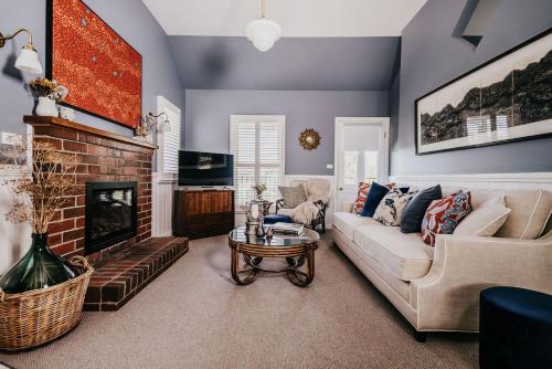 a living room with a couch and a fireplace at Candlebark Daylesford in Daylesford