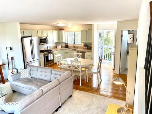 a living room with a couch and a table and a kitchen at Modern & Cozy Gem ~ Walk to the Beach ~ Queen Beds in Carpinteria