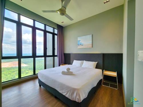 a bedroom with a large bed and large windows at D pristine Family Suites By Holi in Johor Bahru