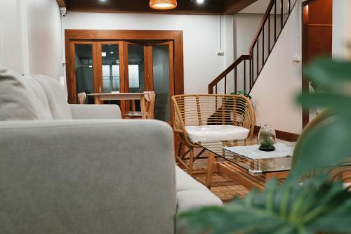 a living room with two couches and a table at Home Story Hostel Chiang Mai in Chiang Mai