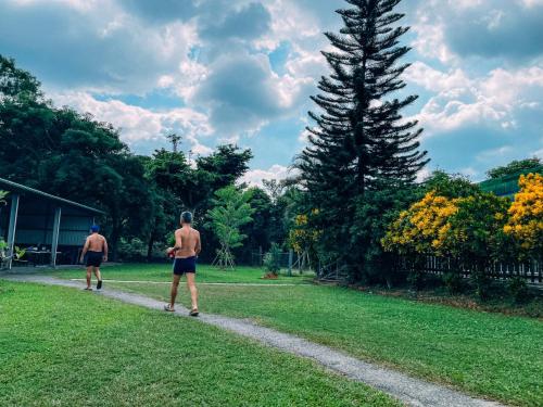 two men flying a kite in a park at CDR Hotspring Resort in Liugui