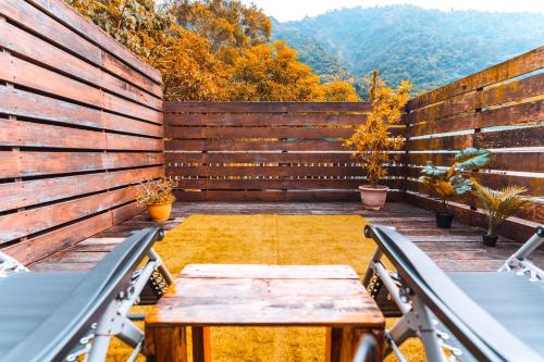 a patio with a wooden fence and a wooden table at CDR Hotspring Resort in Liugui