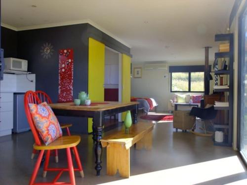 a living room with a table and a kitchen at Deshons Country Retreat in Kingaroy