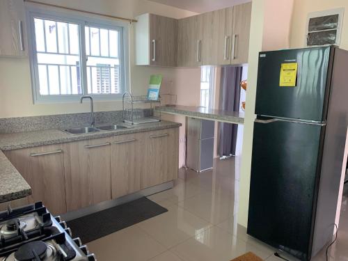 a kitchen with a black refrigerator and a sink at 3 bed 3 bath Friendly, Friendship area, Fibre bdb in Angeles