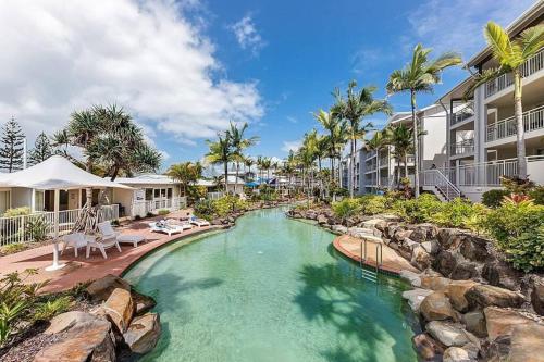 a pool at a resort with a water slide at Alex Heads Beachfront Resort King Bed Studio Room in Alexandra Headland