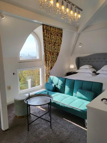 a bedroom with a blue couch and a bed at Villa al Tempio in Pazardzhik