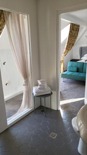 a room with a window with a table and a couch at Villa al Tempio in Pazardzhik