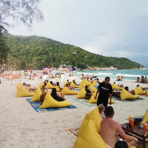 a group of people sitting in inflatables on a beach at Haadrin village Fullmoon in Haad Rin