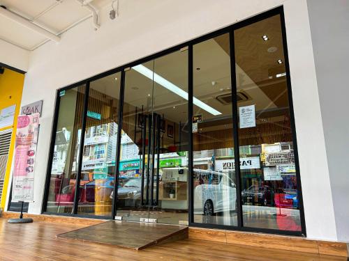 a store front with a lot of glass windows at Cel Hotel in Skudai