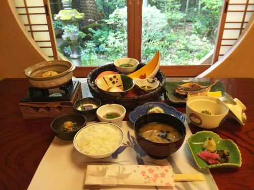 a table with many different bowls of food on it at Yamagaso in Hakone
