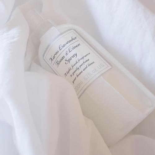a bottle of soap sitting on top of a white shirt at River Bend Guesthouses in Graaff-Reinet