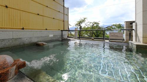 a pool of water in the middle of a building at Hotel Koryu in Fujikawaguchiko