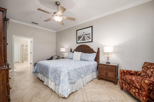 a bedroom with a bed and a couch and a ceiling fan at 835 Cinnamon Beach, 3 Bedroom, Sleeps 8, Diamond Rated, Ocean Front, 2 Pools in Palm Coast