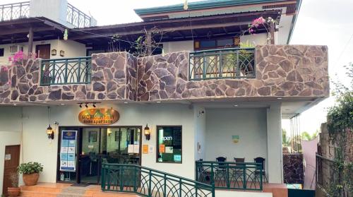 a building with a stone facade and a restaurant at MC Mountain Home in Tagaytay