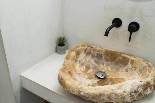 a stone sink sitting on a counter in a bathroom at Magnolia Villas Thassos in Potos