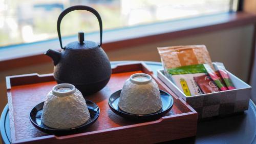 a tea set on a table with a tea pot at Sora Niwa Terrace Kyoto Bettei in Kyoto