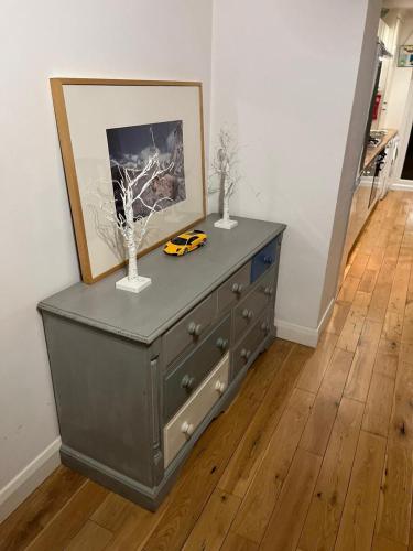 a dresser with a picture on top of it in a room at Chiswick two minutes station home in London