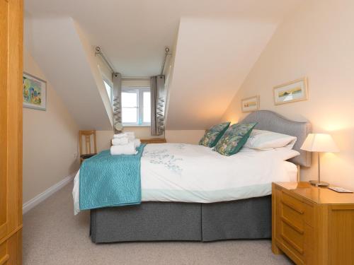 a bedroom with a large bed in a attic at Laurellie in Carbis Bay