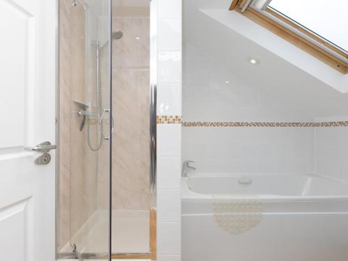 a bathroom with a shower with a glass door at Laurellie in Carbis Bay