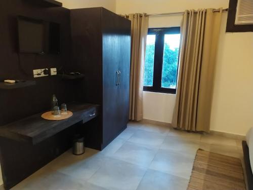 a bathroom with a sink and a window at Hotel Holiday Highlights in Rāmnagar