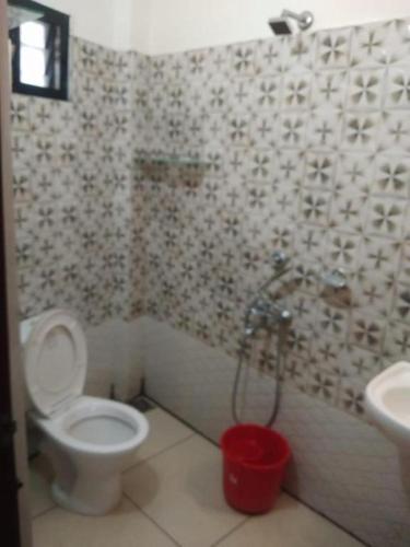 a bathroom with a toilet and a sink at HISHAM SUITES in Cochin