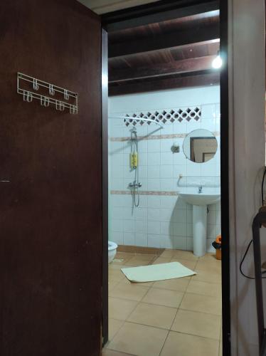 a bathroom with a toilet and a sink at Tikoté Chwit point 1 in Cayenne