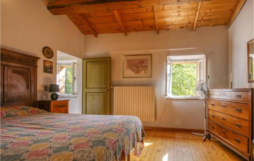 a bedroom with a bed and a dresser and two windows at Cozy Home In Trebbiantico Di Pesaro With House A Panoramic View in Trebbiantico