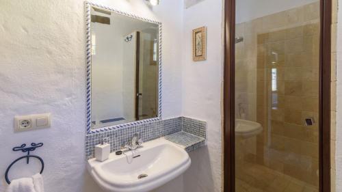 a bathroom with a sink and a mirror and a shower at Arroyo del Moro Gaucín by Ruralidays in Gaucín