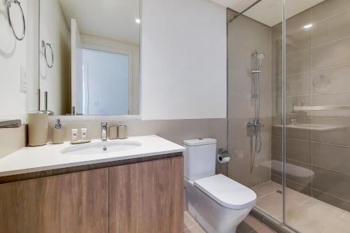 a bathroom with a toilet and a sink and a shower at Primestay - Executive Residences in Dubai Hills Estate in Dubai