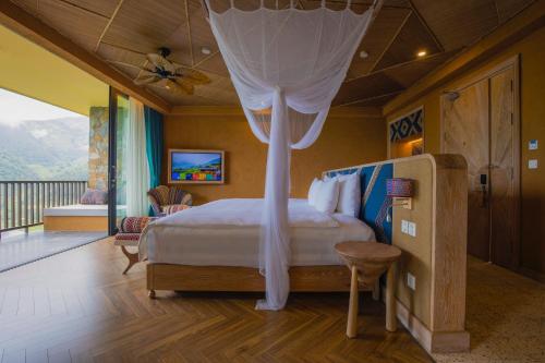 a bedroom with a bed with a canopy at Le Champ Tu Le Resort Hot Spring & Spa in Yen Bai