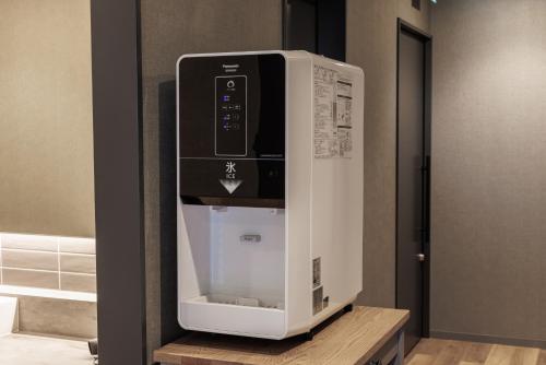 a coffee machine sitting on a shelf in a room at Minakami Onsen Aratashi Minakami in Minakami