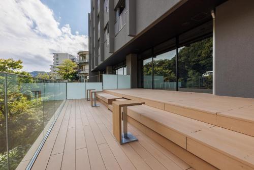 a building with benches on the outside of it at Minakami Onsen Aratashi Minakami in Minakami