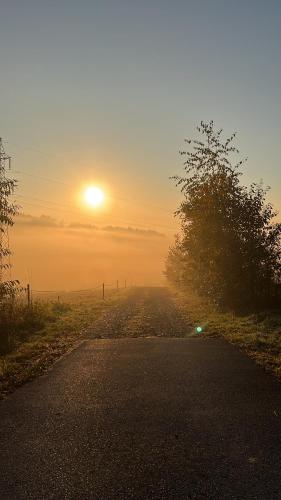 an empty road with the sunset in the background at Chatka Biesczadersko in Lutowiska
